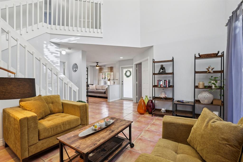 972 Azure Lane Weston, FL 33326 - Photo 23 of 61 a living room with furniture a rug and a chandelier