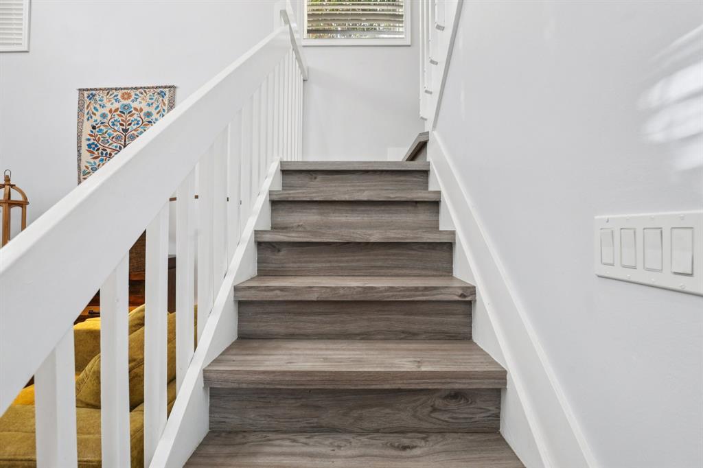 972 Azure Lane Weston, FL 33326 - Photo 26 of 61 a view of staircase with lots of frames on wall and a window