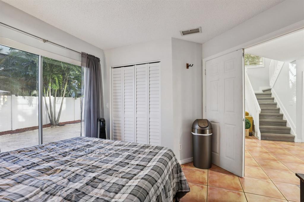 972 Azure Lane Weston, FL 33326 - Photo 28 of 61 a bedroom with a bed and a shower