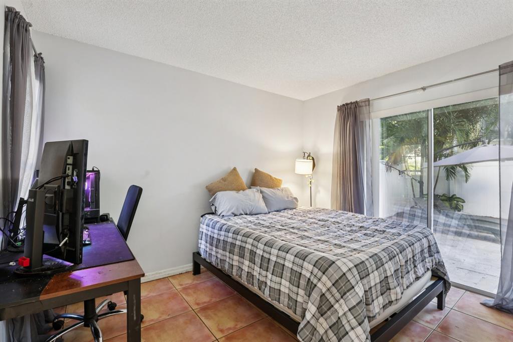 972 Azure Lane Weston, FL 33326 - Photo 29 of 61 a bedroom with a bed a large window and chair