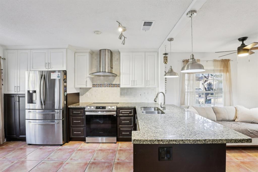 972 Azure Lane Weston, FL 33326 - Photo 3 of 61 a kitchen with stainless steel appliances granite countertop a sink refrigerator and cabinets