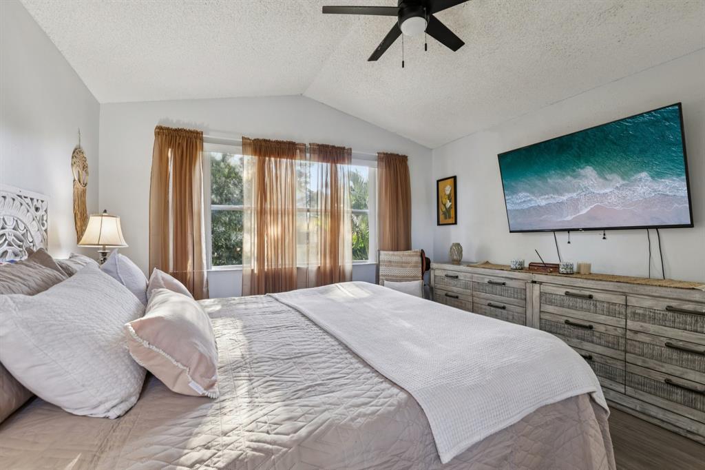 972 Azure Lane Weston, FL 33326 - Photo 31 of 61 a bedroom with a bed and a flat screen tv