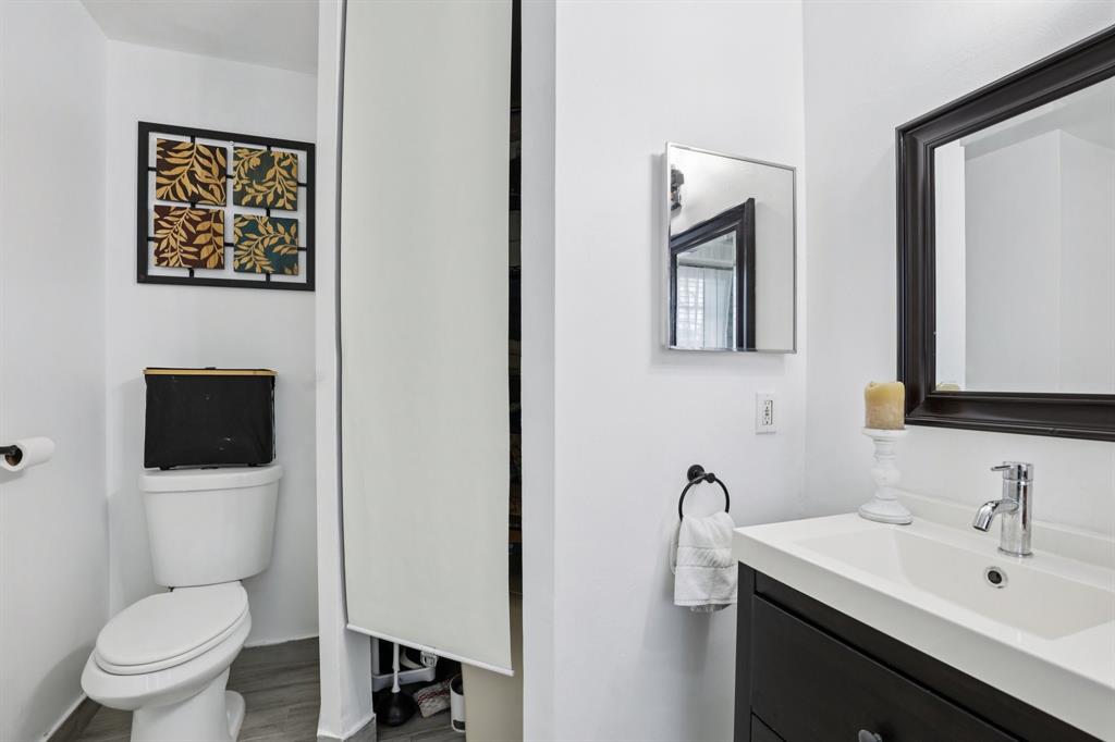 972 Azure Lane Weston, FL 33326 - Photo 34 of 61 a bathroom with a toilet a sink and mirror