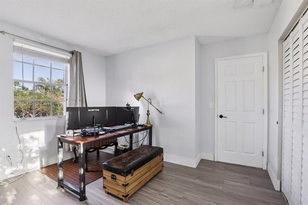 972 Azure Lane Weston, FL 33326 - Photo 40 of 61 a room with furniture and a flat screen tv