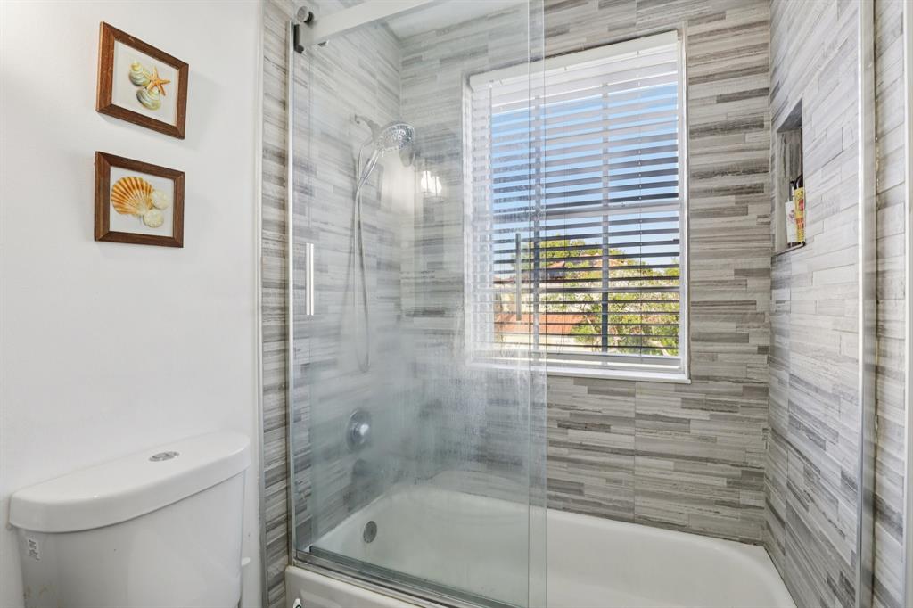 972 Azure Lane Weston, FL 33326 - Photo 42 of 61 a bathroom with a bathtub and a shower