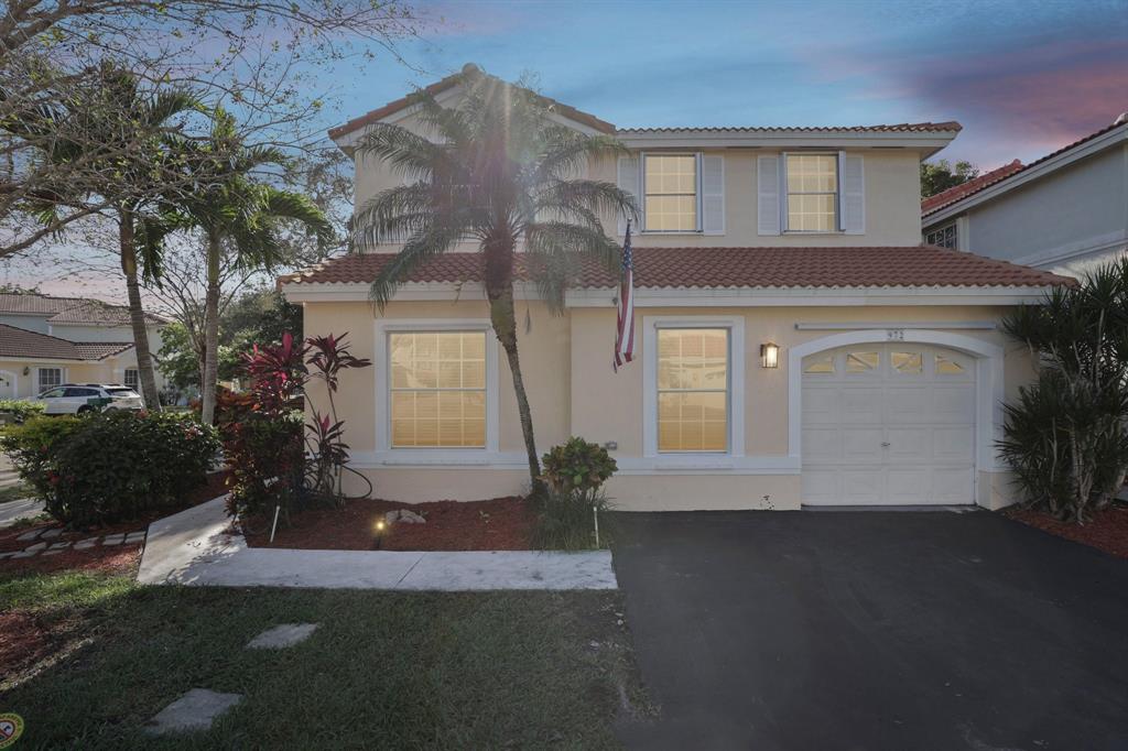972 Azure Lane Weston, FL 33326 - Photo 58 of 61 a front view of a house with a yard