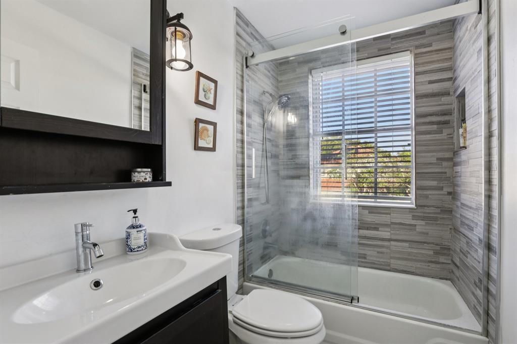 972 Azure Lane Weston, FL 33326 - Photo 7 of 61 a bathroom with a sink a toilet and shower