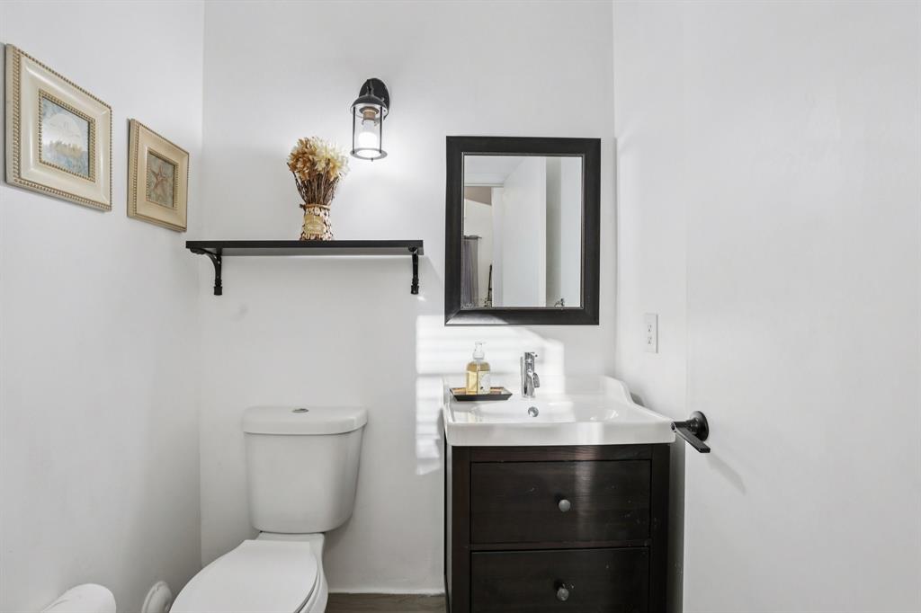 972 Azure Lane Weston, FL 33326 - Photo 8 of 61 a bathroom with a toilet sink and mirror