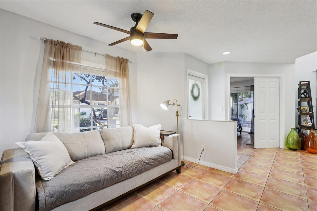 972 Azure Lane Weston, FL 33326 - Photo 10 of 61 a living room with furniture and a large window