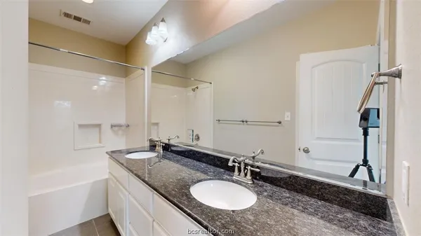 a view of a livingroom with a ceiling fan and window
