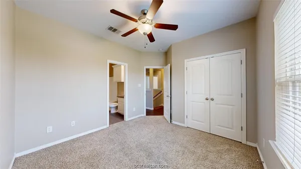 a bathroom with a granite countertop sink toilet a mirror and shower