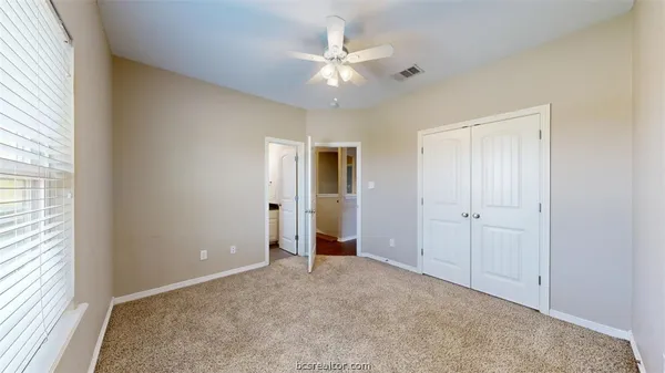 a bathroom with a granite countertop sink toilet mirror and bathtub