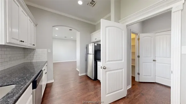 a view of a kitchen cabinets and stainless steel appliances