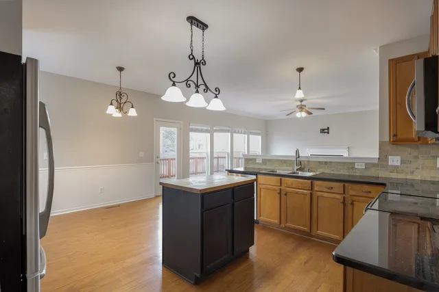 a kitchen with center island and stainless steel appliances