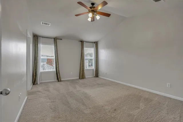a view of a livingroom with a ceiling fan and window