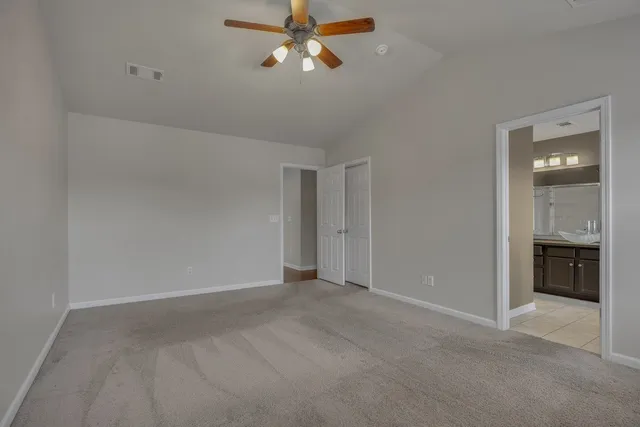 a view of an empty room with closet