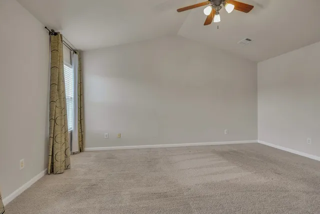 an empty room with a empty space and a chandelier fan