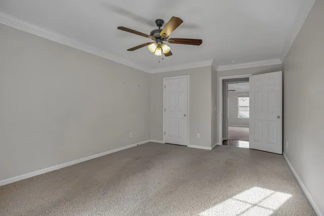 a view of an empty room with a ceiling fan