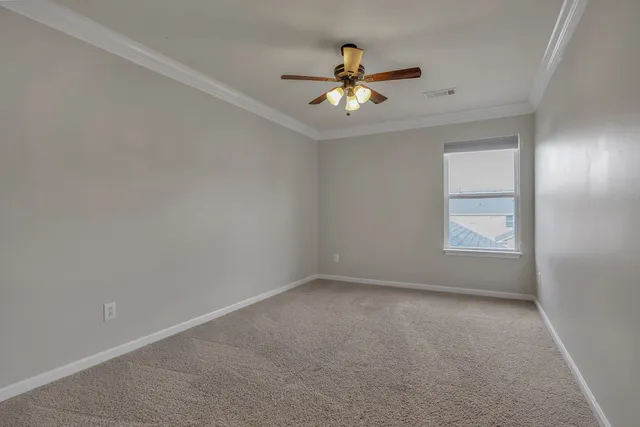 a view of room with ceiling fan and window