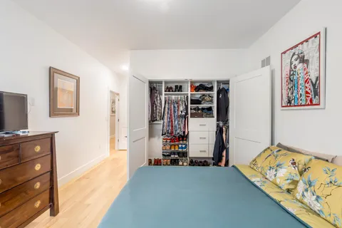 a view of a bedroom with furniture and window