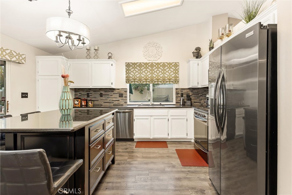 2165 Mintzer Street Colton, CA 92324 - Photo 11 of 40 a kitchen with stainless steel appliances granite countertop a sink refrigerator and cabinets