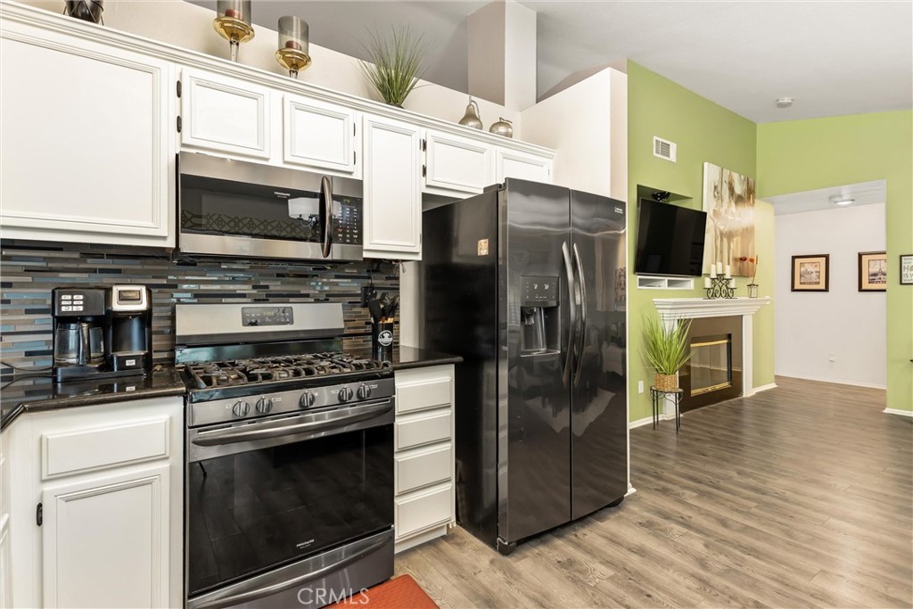 2165 Mintzer Street Colton, CA 92324 - Photo 12 of 40 a kitchen with stainless steel appliances a stove microwave and refrigerator