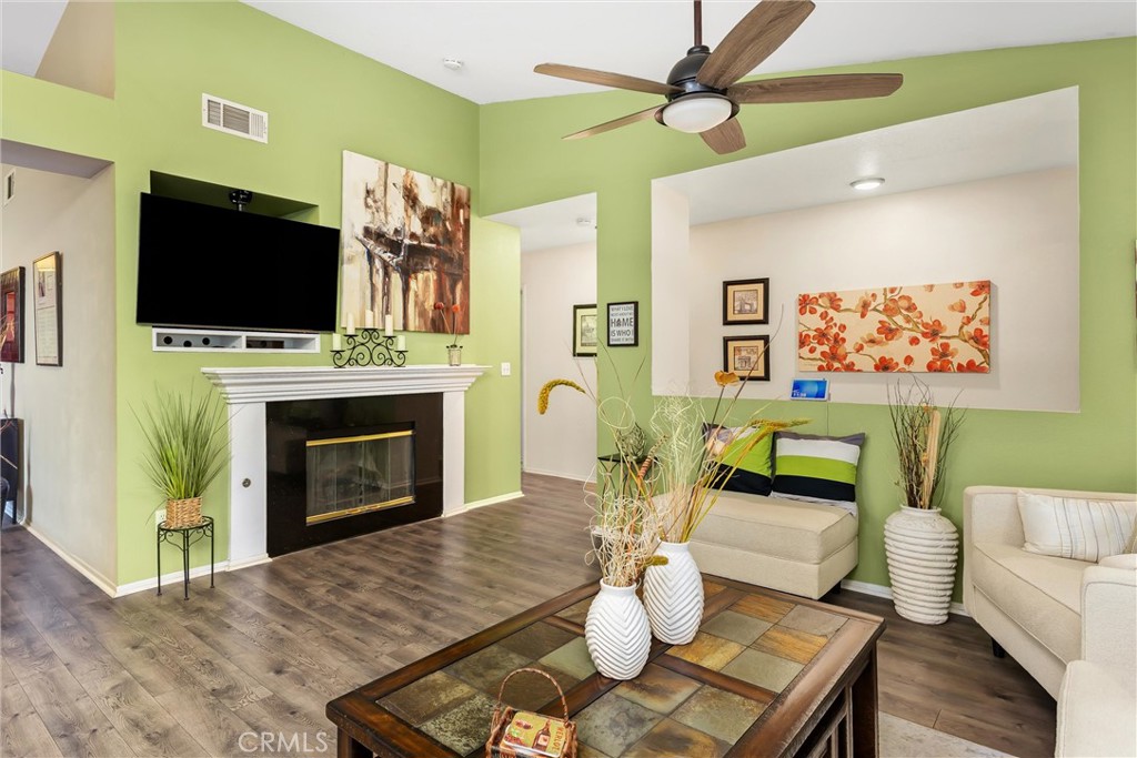 2165 Mintzer Street Colton, CA 92324 - Photo 9 of 40 a living room with furniture a flat screen tv and a fireplace