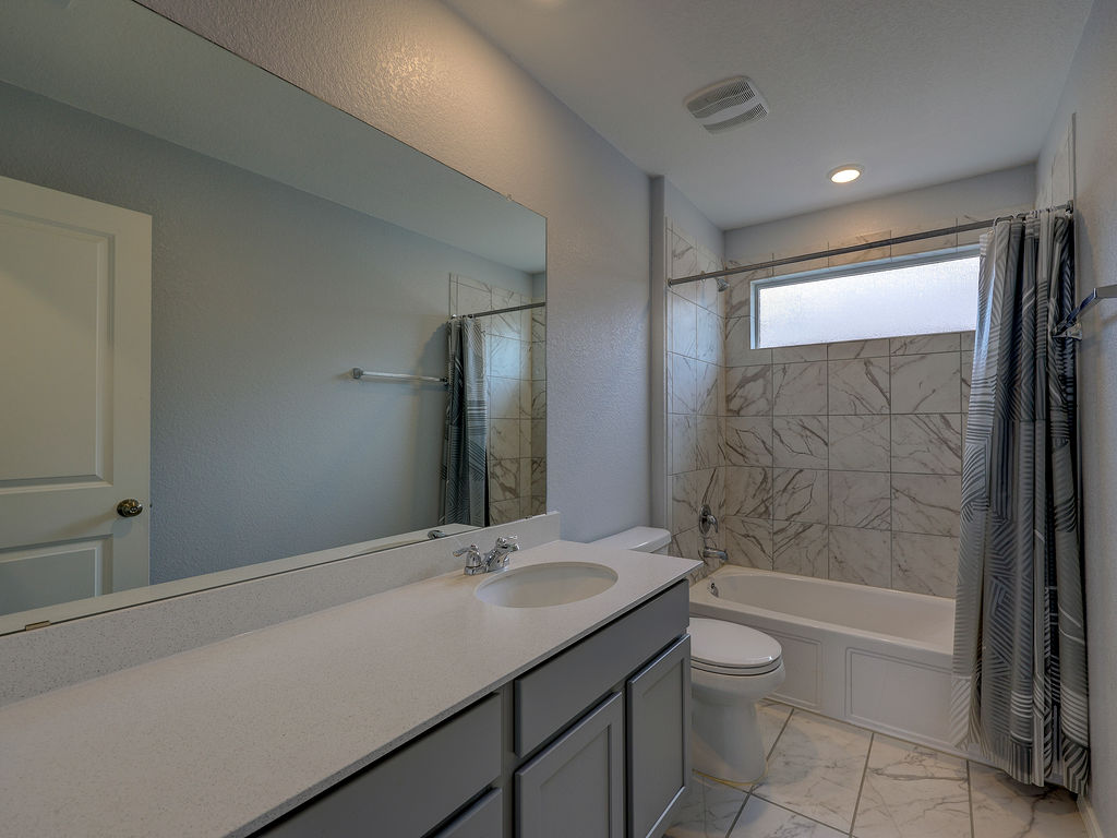 1716 Frontenac Street Leander, TX 78641 - Photo 29 of 34 a bathroom with a sink toilet and shower