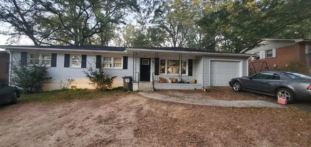 a view of a house that has a parked car