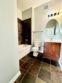 1464 South Michigan Avenue, Unit 1507 Chicago, IL 60605 - Photo 8 of 13 a bathroom with a sink toilet and shower