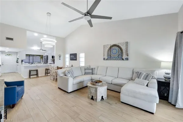 a living room with furniture and a wooden floor