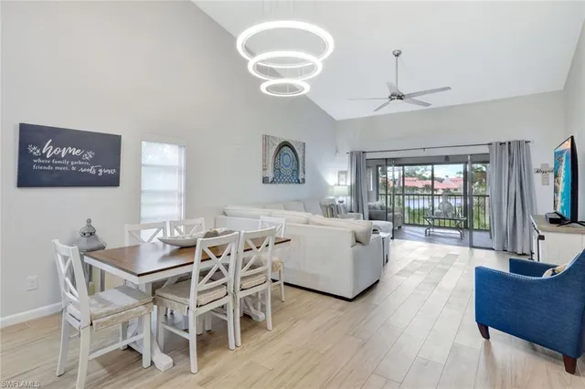 a living room with furniture wooden floor and a chandelier