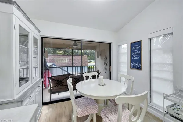 a view of a dining room with furniture window and wooden floor