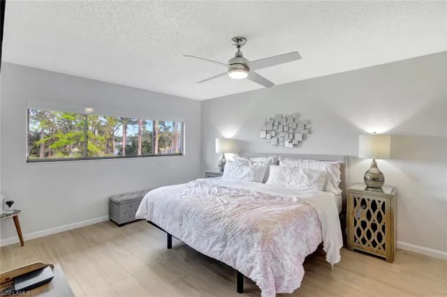 a bedroom with a bed and painting on the wall
