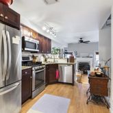 a kitchen with stainless steel appliances granite countertop a refrigerator stove and sink