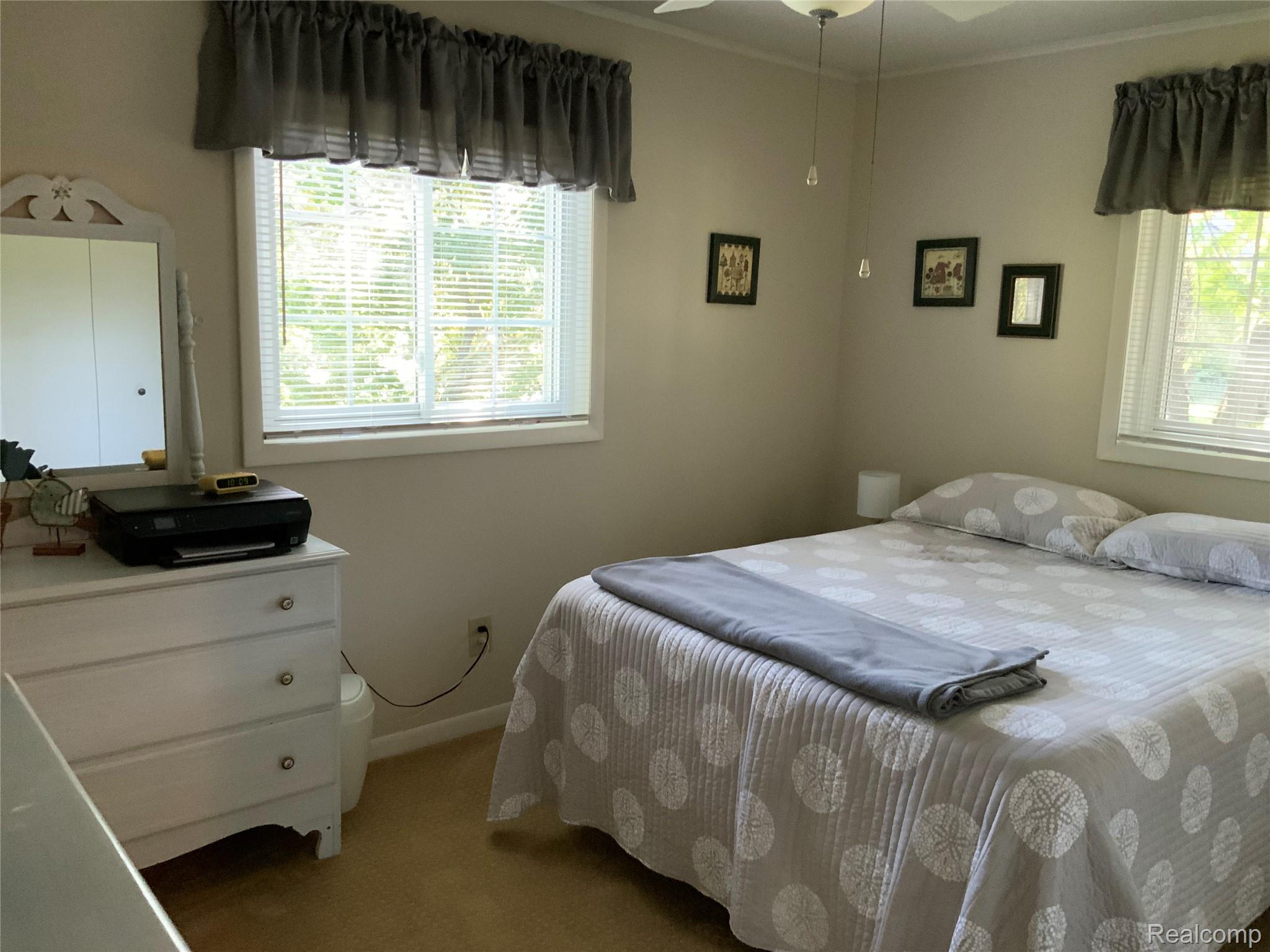 3828 Morgan Road Lake Orion, MI 48359 - Photo 11 of 39 Light-toned walls, ceiling fan with illumination, and multiple windows with blinds
