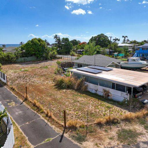 Elepaio Road Kekaha, HI 96752 - Photo 6 of 12 a view of a swimming pool with lawn chairs under an umbrella