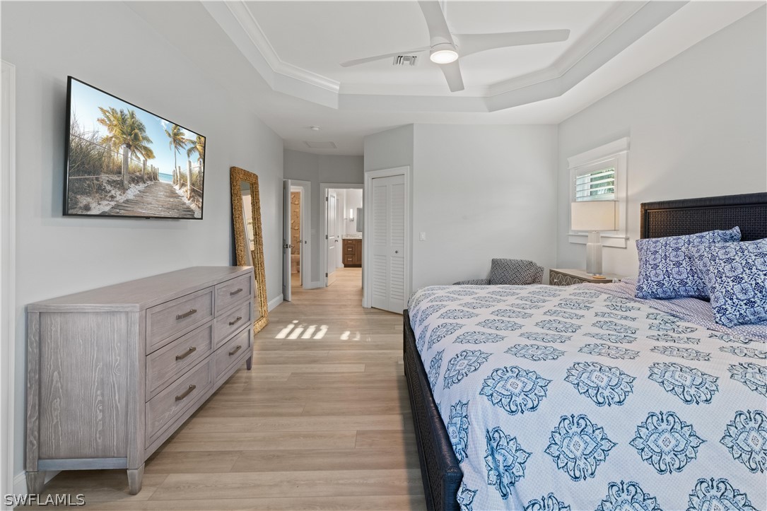 5294 Umbrella Pool Road Sanibel, FL 33957 - Photo 18 of 44 a bedroom with a large bed and a chandelier