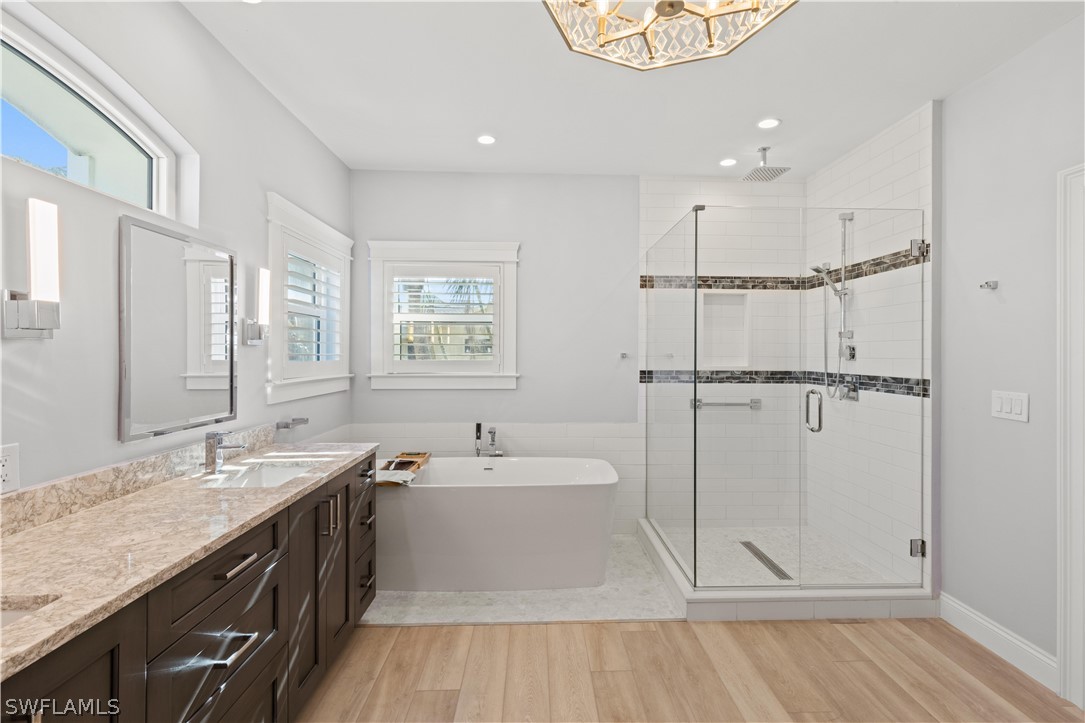 5294 Umbrella Pool Road Sanibel, FL 33957 - Photo 21 of 44 a spacious bathroom with a sink mirror and a bathtub