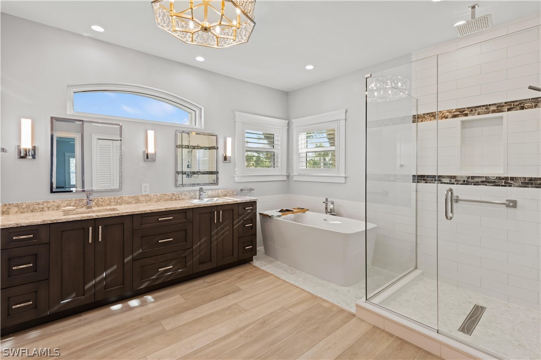 5294 Umbrella Pool Road Sanibel, FL 33957 - Photo 22 of 44 a spacious bathroom with a tub sink shower and mirror