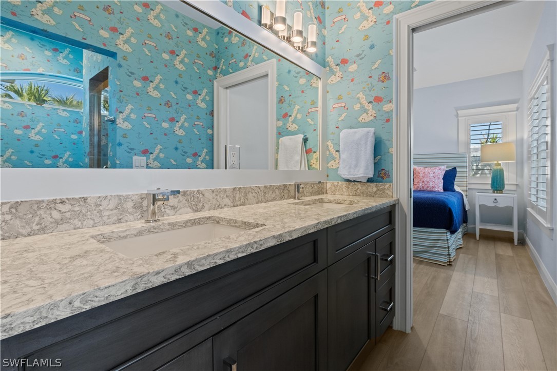 5294 Umbrella Pool Road Sanibel, FL 33957 - Photo 25 of 44 a bathroom with a granite countertop sink and a mirror