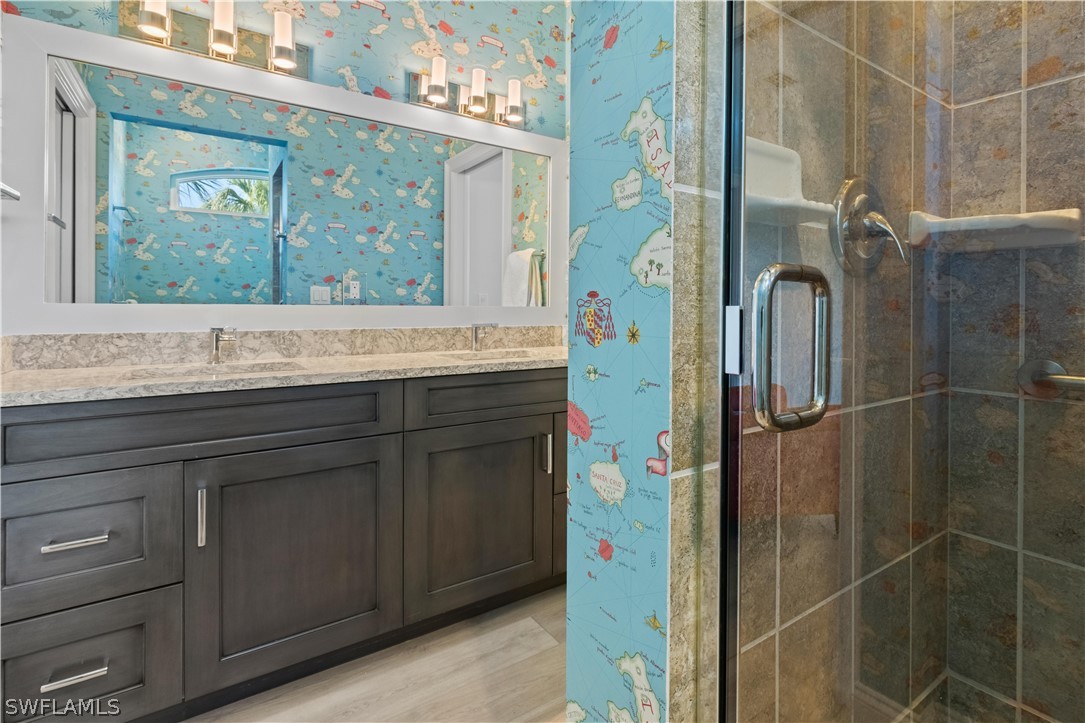 5294 Umbrella Pool Road Sanibel, FL 33957 - Photo 26 of 44 a bathroom with a granite countertop sink a mirror and shower