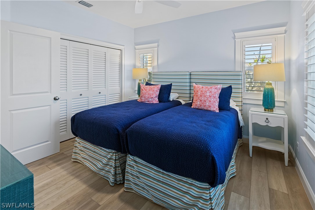 5294 Umbrella Pool Road Sanibel, FL 33957 - Photo 27 of 44 a bedroom with a bed and a cabinets