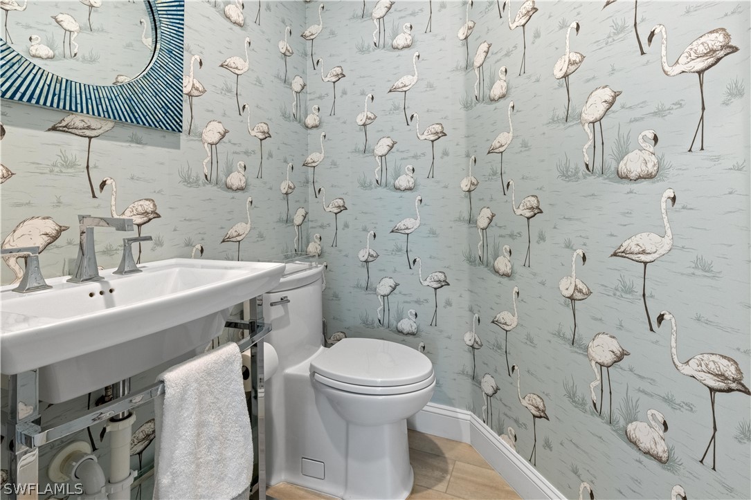 5294 Umbrella Pool Road Sanibel, FL 33957 - Photo 29 of 44 a bathroom with a sink a toilet and a mirror