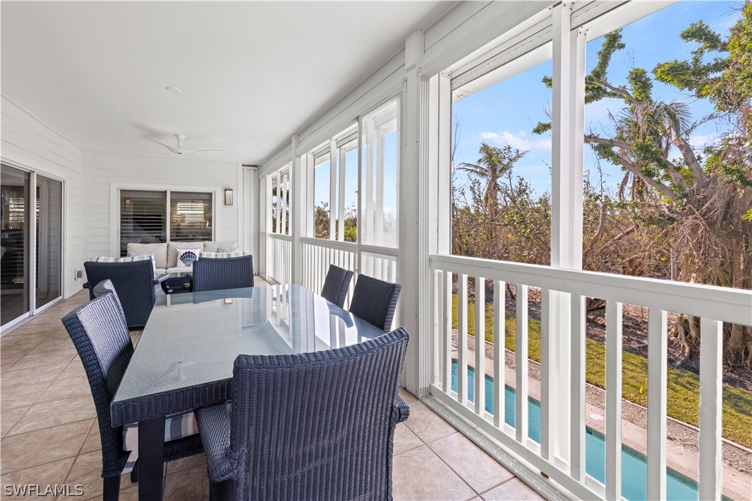 5294 Umbrella Pool Road Sanibel, FL 33957 - Photo 32 of 44 a view of a dining room with furniture a rug and wooden floor