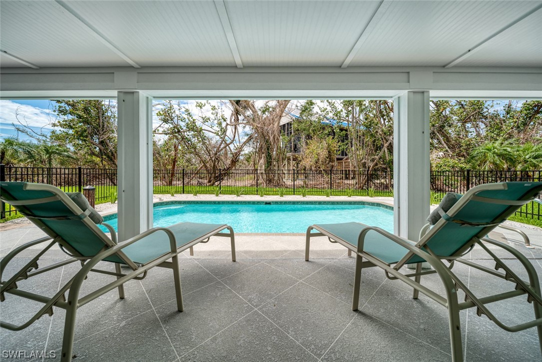5294 Umbrella Pool Road Sanibel, FL 33957 - Photo 33 of 44 a view of a porch with furniture and garden