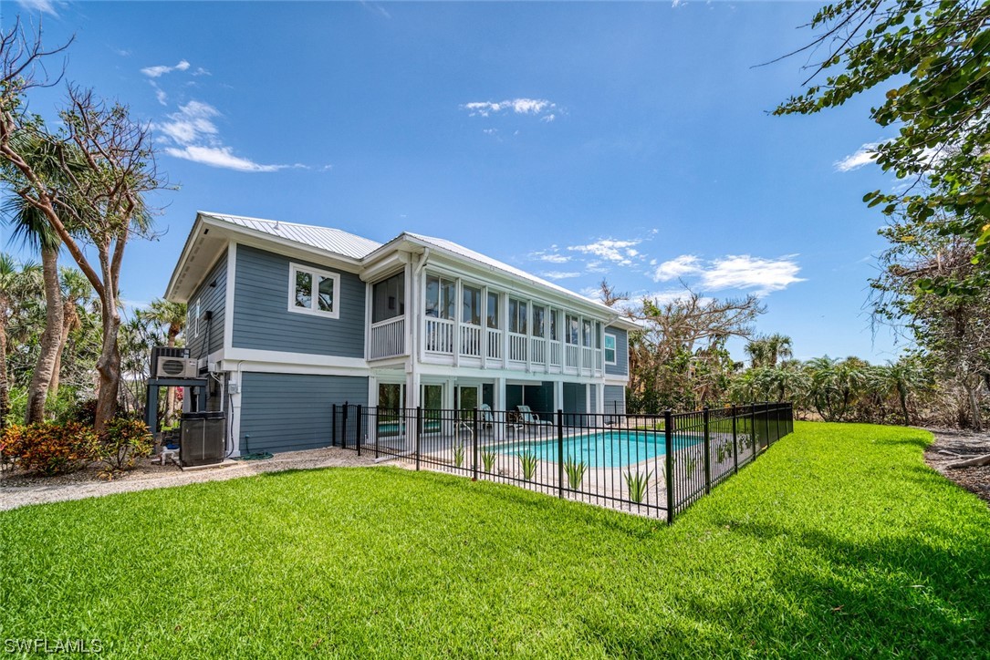 5294 Umbrella Pool Road Sanibel, FL 33957 - Photo 37 of 44 a view of house with a yard and potted plants