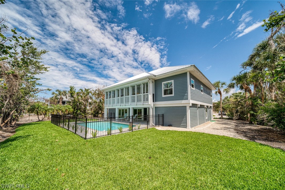 5294 Umbrella Pool Road Sanibel, FL 33957 - Photo 38 of 44 a view of house with yard and outdoor seating