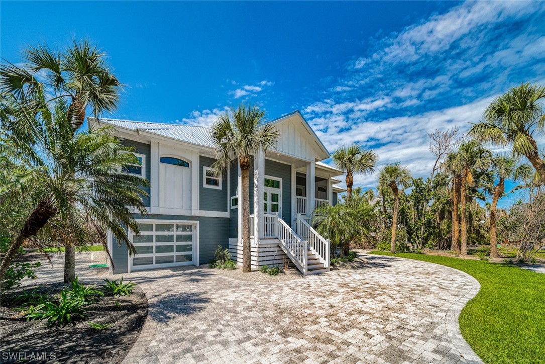 5294 Umbrella Pool Road Sanibel, FL 33957 - Photo 4 of 44 a view of a house with a tree in front of a house