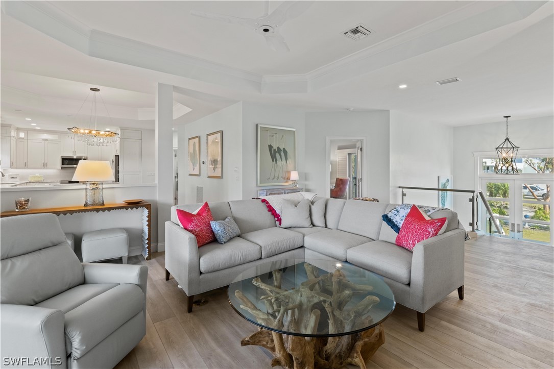5294 Umbrella Pool Road Sanibel, FL 33957 - Photo 8 of 44 a living room with furniture and a dining table with wooden floor